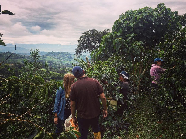 Alyssa DeVincentis and coffee producer Leonardo Villagomez interview a farm laborer
