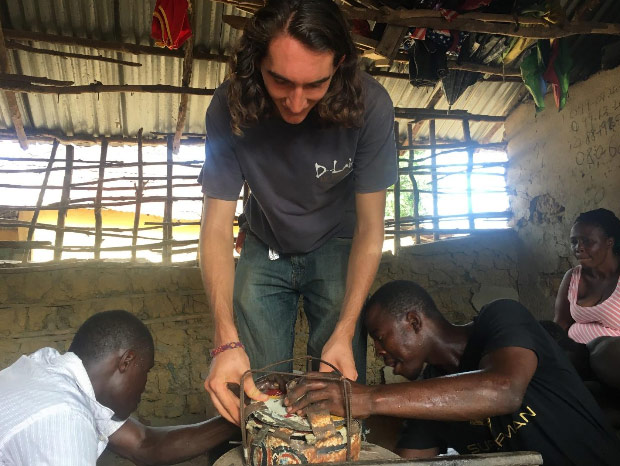 Peter works on creating a locally-built ethanol stove with local metalsmiths
