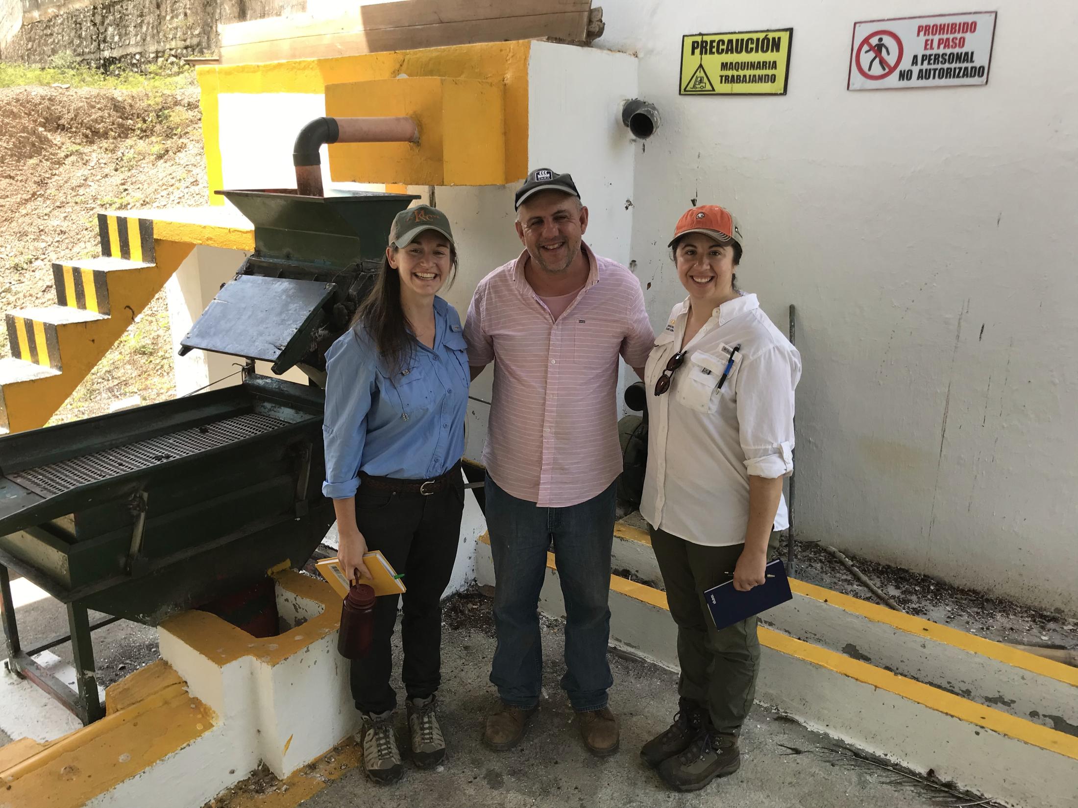 Researchers Evie Smith (left) and Lisa Artuso (right) stand with Antonio Recimos (center) at his farm Finca Nueva Armenia in Huehuetenango, Guatemala