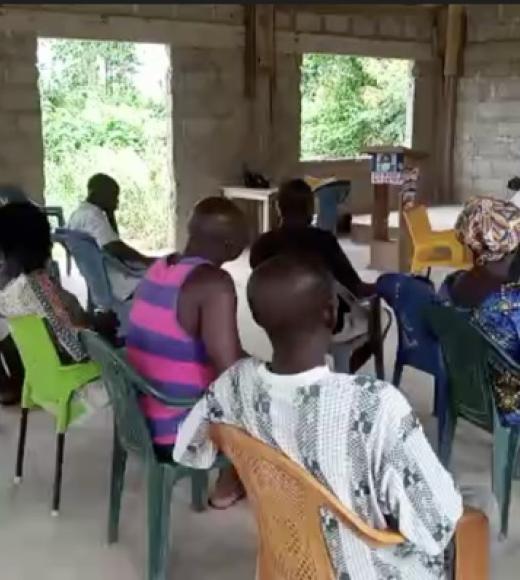 Man sits facing group of people during focus group meting