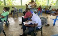 Room of people taking paper surveys